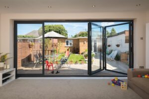 origin ob-49 bifold doors in black opening out to a patio area