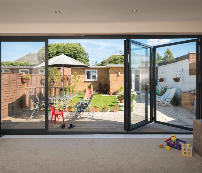 origin ob-49 bifold doors in black opening out to a patio area