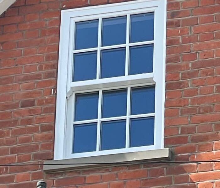 White Georgian style quickslide sash windows in a brick opening