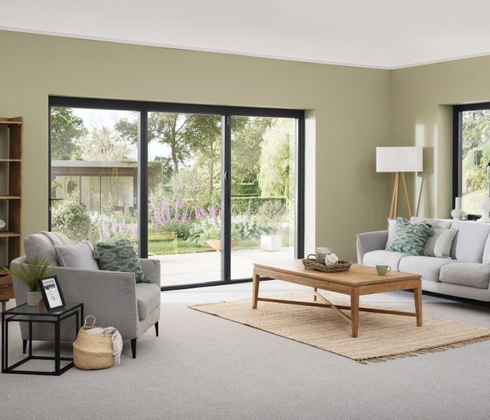 Origin OB-36+ Contemporary slimline bifold door in heritage green in a sophisticated lounge