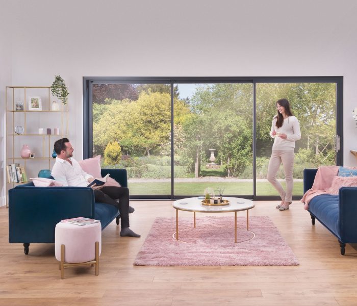 Origin os-44 sliding doors in a lounge setting with happy couple