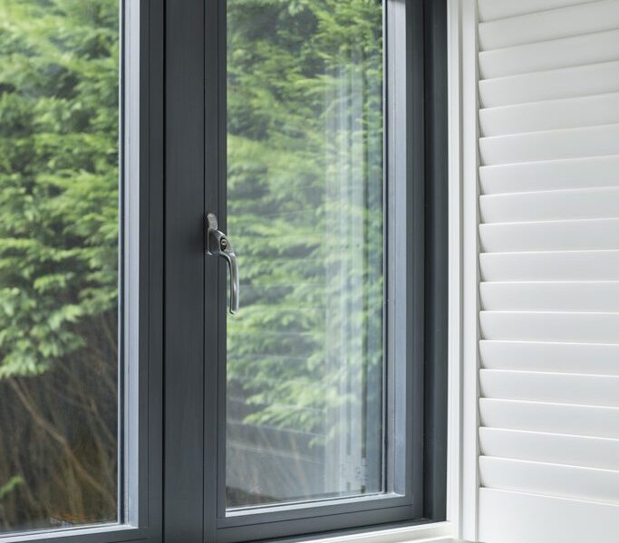 residence 2 windows in a bedroom setting with white internal shutters